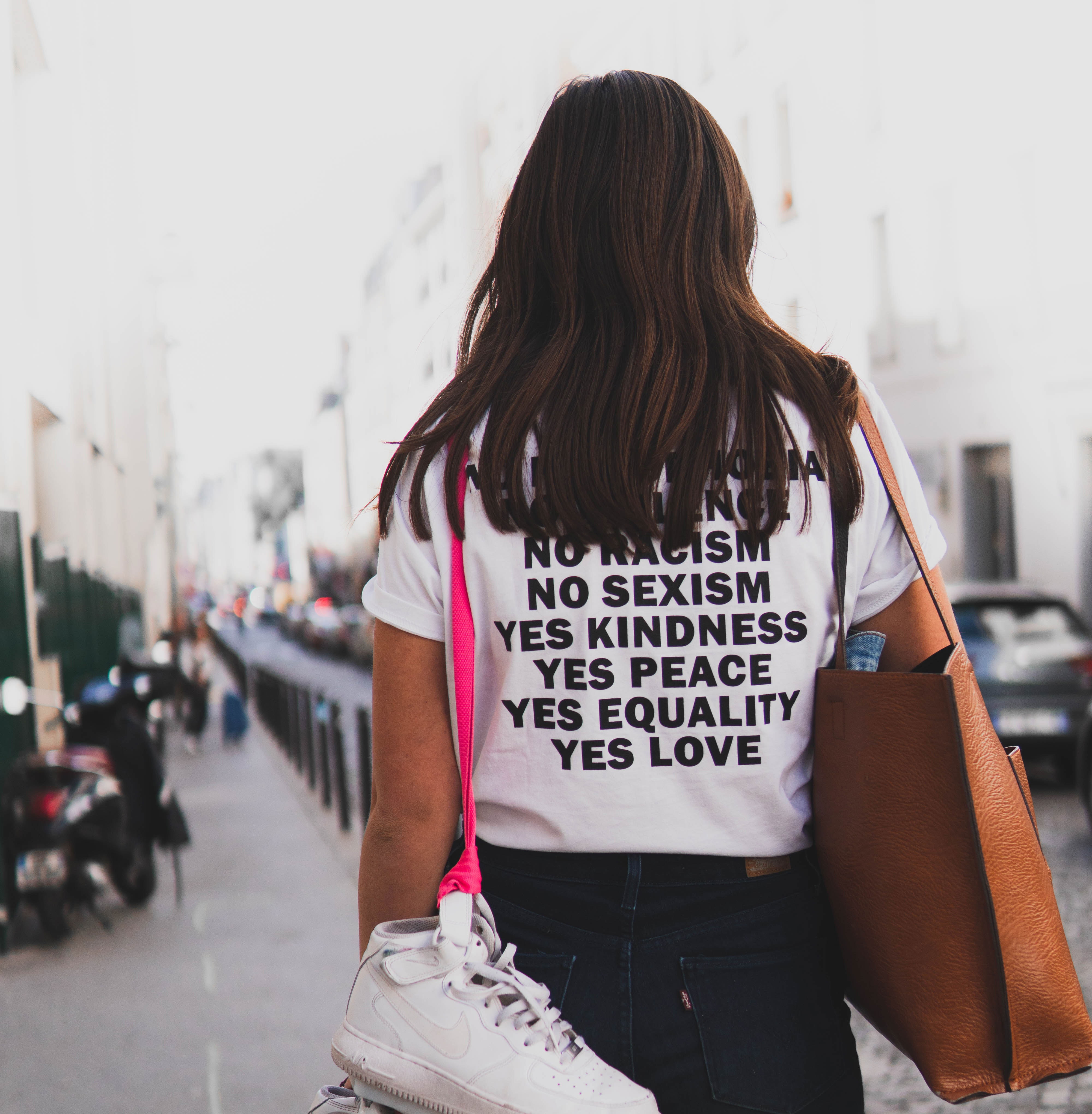 A carefree girl wearing a printed T-Shirt with a message for Humanity